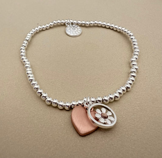 Silver plated stretch bracelet with daisy and heart charms